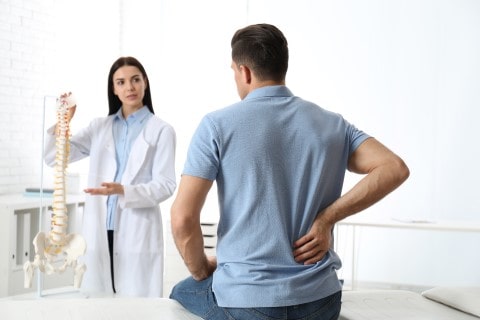 Doctor explicando el ajuste quiropráctico
